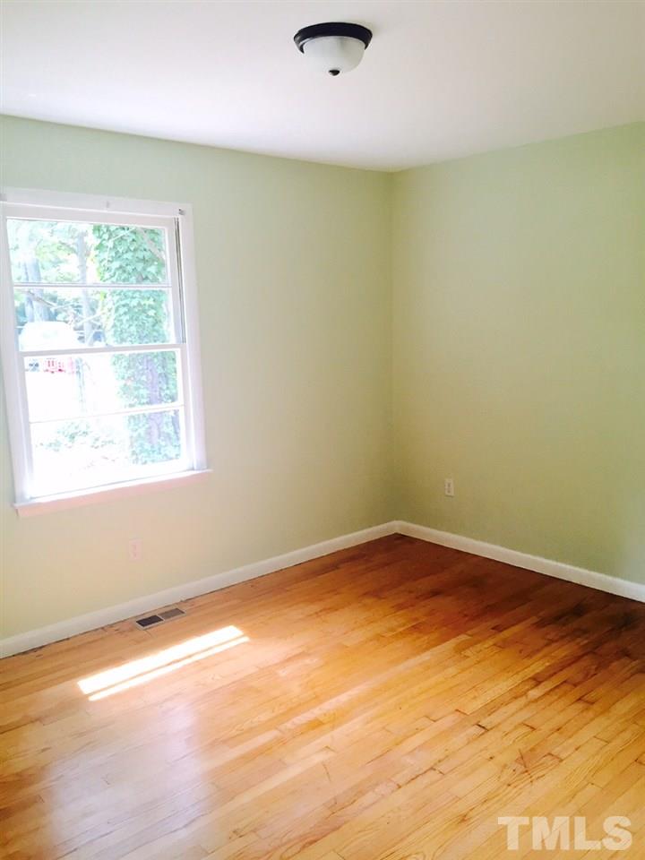 2706 Milburnie Road Raleigh, NC 27610 - Photo 7 of 8 an empty room with a window