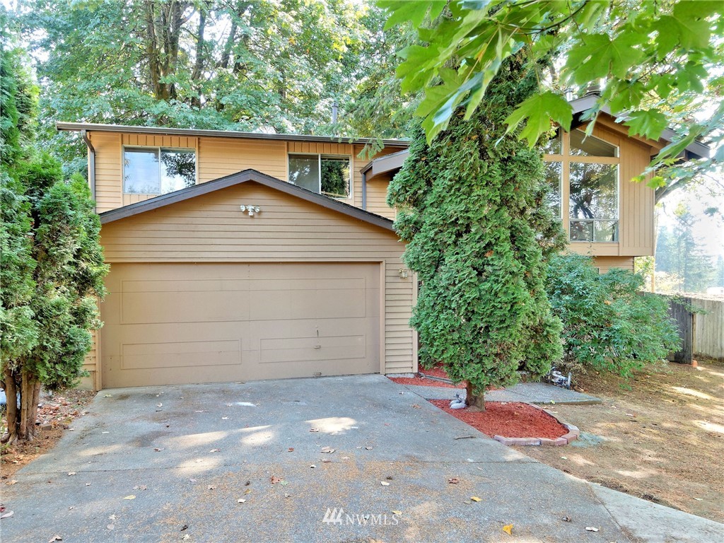 3619 Southeast 19th Court Renton, WA 98058 - Photo 20 of 21 a front view of a house with a yard and garage