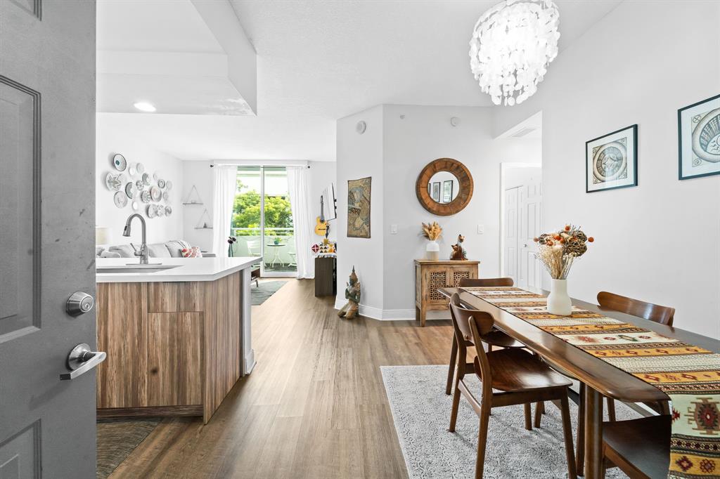 275 Northeast 18th Street, Unit 202 Miami, FL 33132 - Photo 2 of 20 a view of a dining room with furniture window and wooden floor