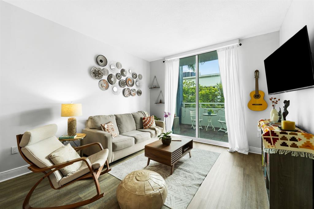 275 Northeast 18th Street, Unit 202 Miami, FL 33132 - Photo 3 of 20 a living room with furniture a flat screen tv and a large window