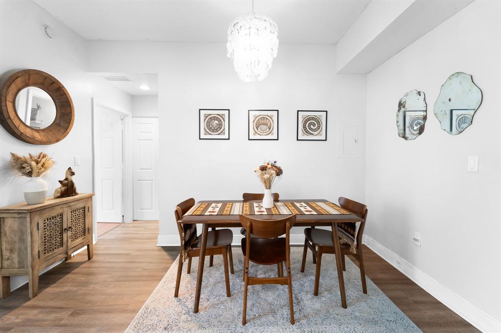 275 Northeast 18th Street, Unit 202 Miami, FL 33132 - Photo 6 of 20 a view of a dining room with furniture and chandelier