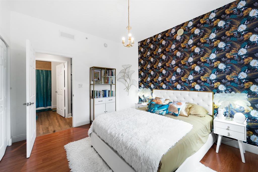 275 Northeast 18th Street, Unit 202 Miami, FL 33132 - Photo 8 of 20 a bedroom with a bed and wooden floor