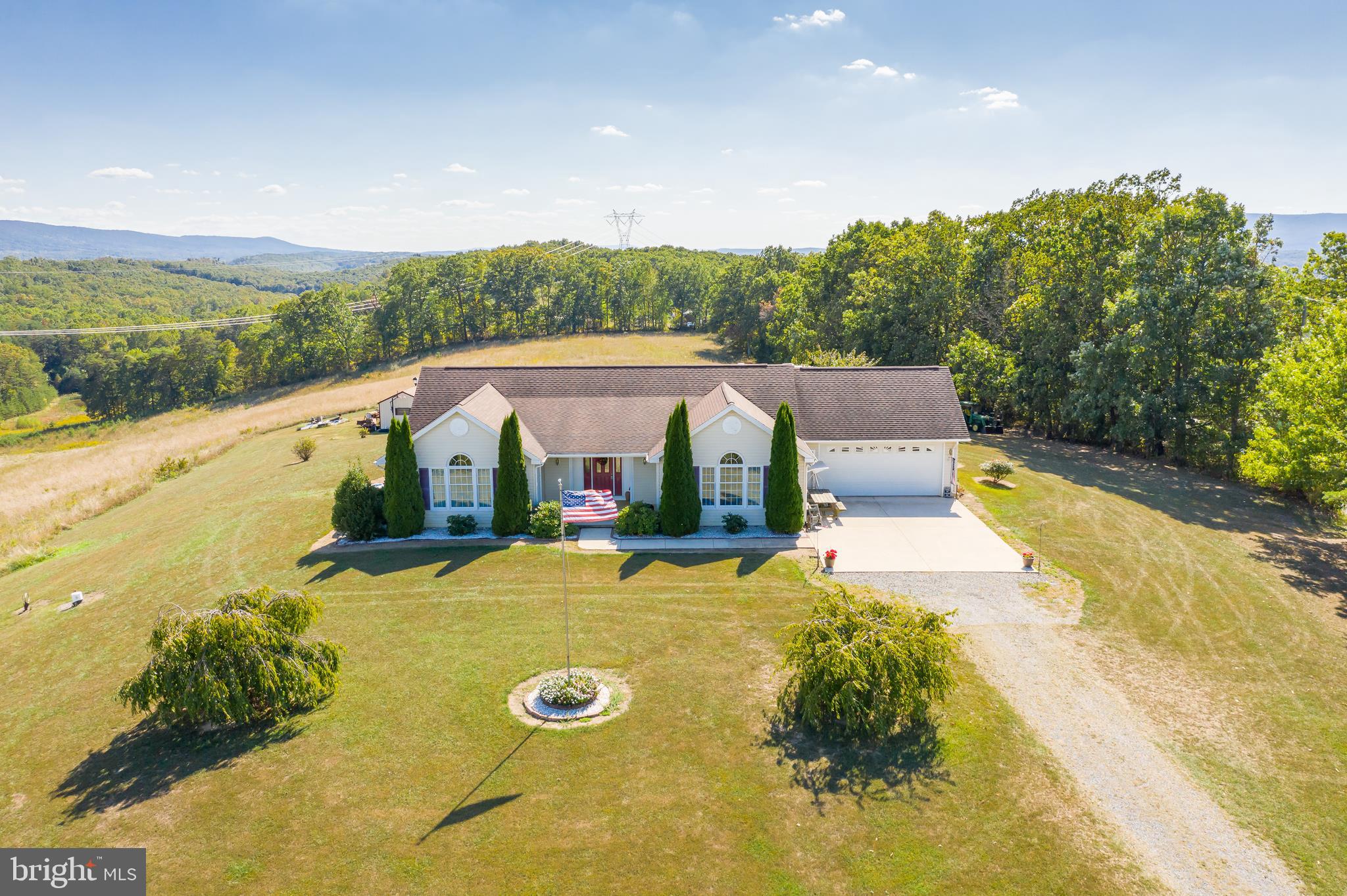 1296 Spielman Road Berkeley Springs, WV 25411 - Photo 65 of 68 with its attached garage and level driveway -