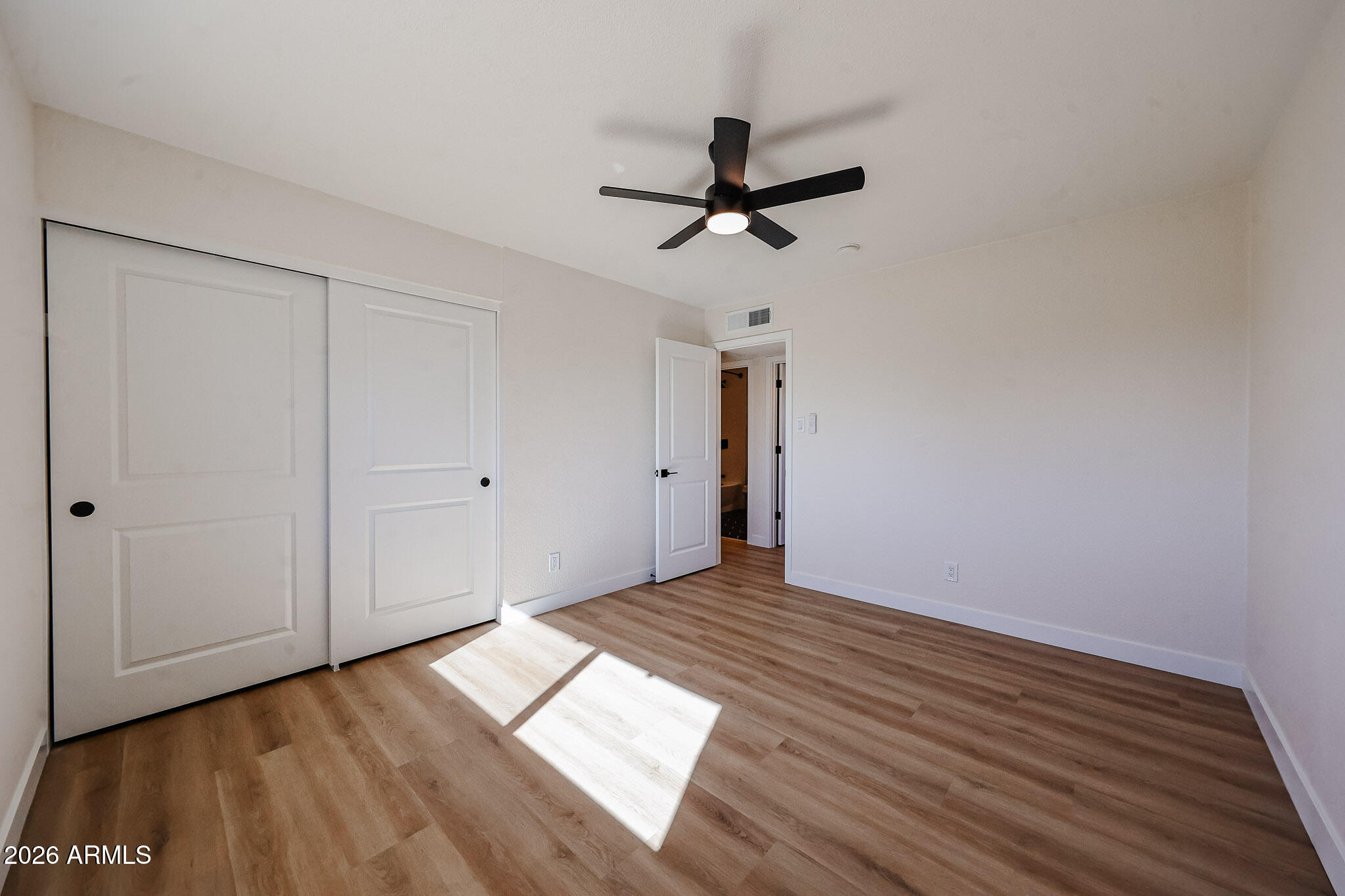 3337 West Ocotillo Road Phoenix, AZ 85017 - Photo 19 of 30 a view of empty room with wooden floor