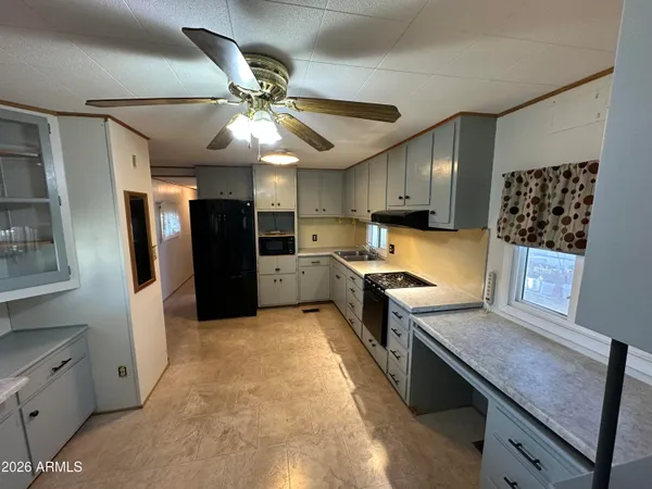 a kitchen with stainless steel appliances granite countertop a stove refrigerator and cabinets