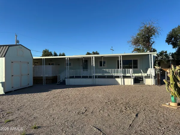 a view of a house with backyard and porch
