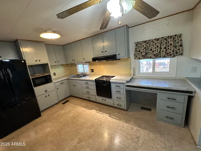 a kitchen with a stove refrigerator and sink