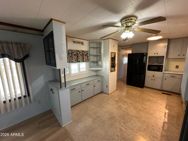 a view of a kitchen with a sink and cabinet area
