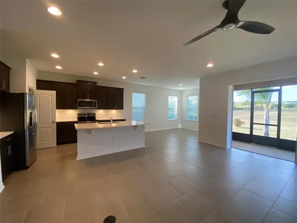a large kitchen with stainless steel appliances kitchen island granite countertop a large counter top and oven