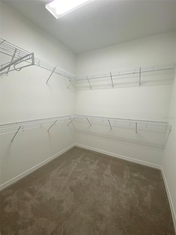 7047 Oxbow Road Minneola, FL 34715 - Photo 15 of 33 a view of a room with racks on the wall
