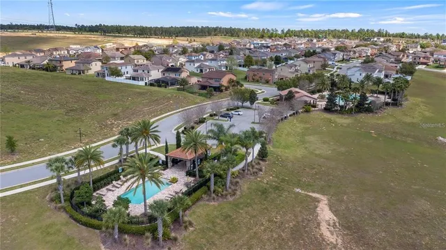 an aerial view of residential houses with outdoor space and swimming pool