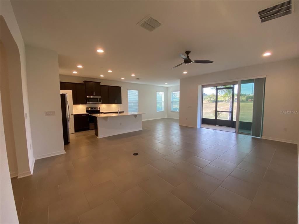 7047 Oxbow Road Minneola, FL 34715 - Photo 9 of 33 a view of a kitchen with a sink and a stove top oven