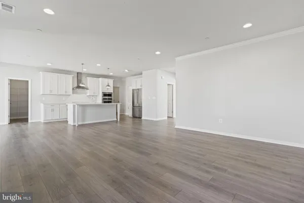 a view of kitchen with wooden floor and electronic appliances