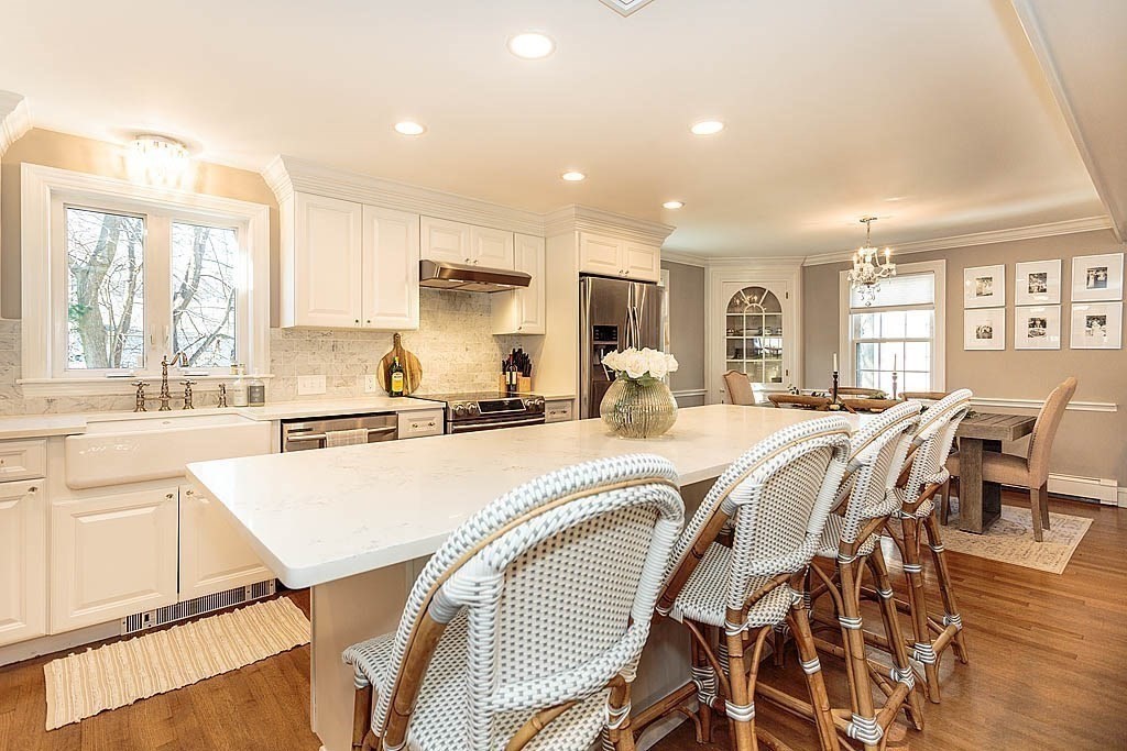 135 Governors Road Milton, MA 02186 - Photo 8 of 21 a large white kitchen with lots of dining table and chairs