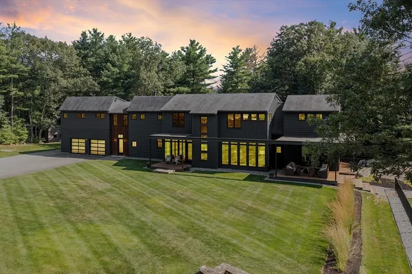 a front view of a house with swimming pool having outdoor seating