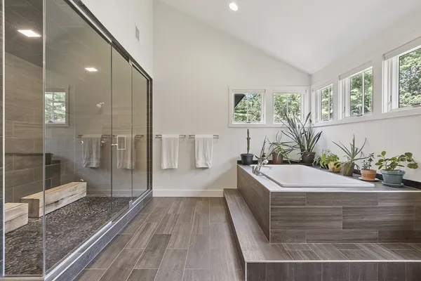 a bathroom with a bathtub and a shower