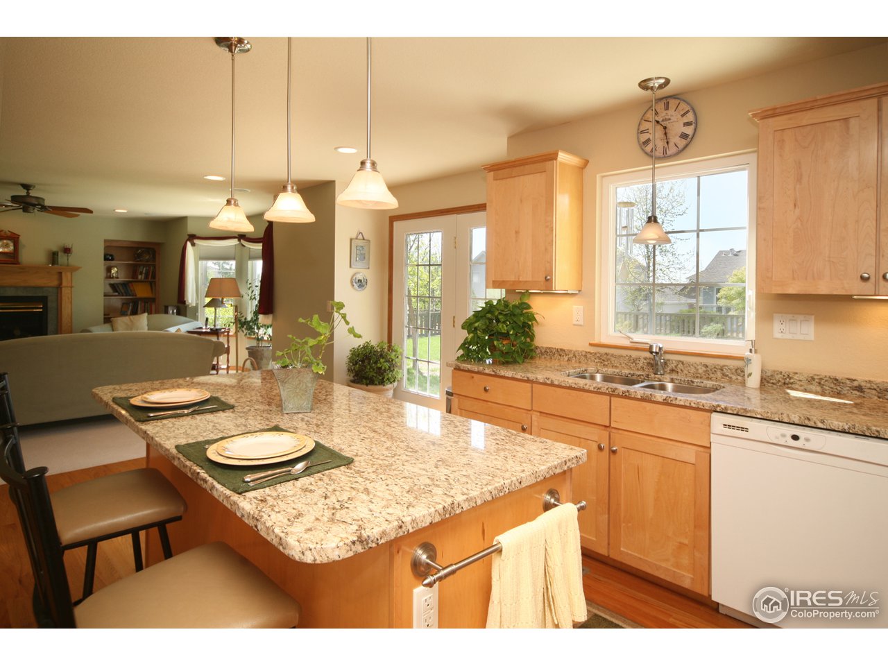 3147 Rookery Road Fort Collins, CO 80528 - Photo 5 of 18 a kitchen with a dining table chairs and sink