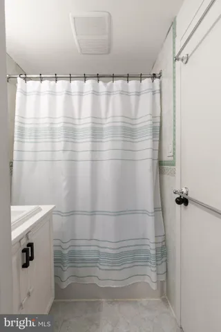 a bathroom with a shower and a sink