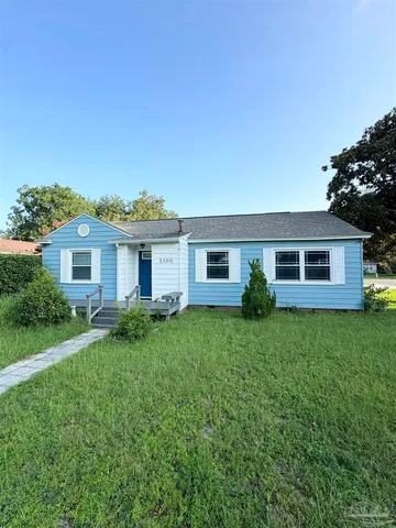 a front view of a house with a garden