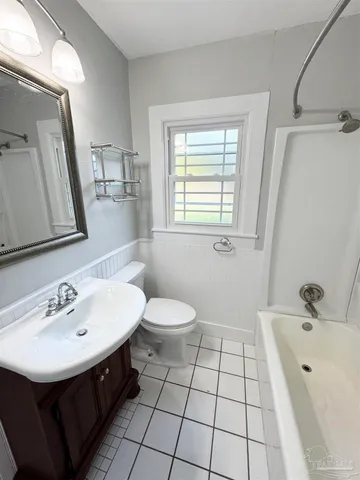 a bathroom with a sink a toilet and mirror