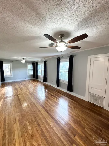 a view of an empty room and wooden floor