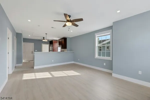 a view of a livingroom with a ceiling fan and window