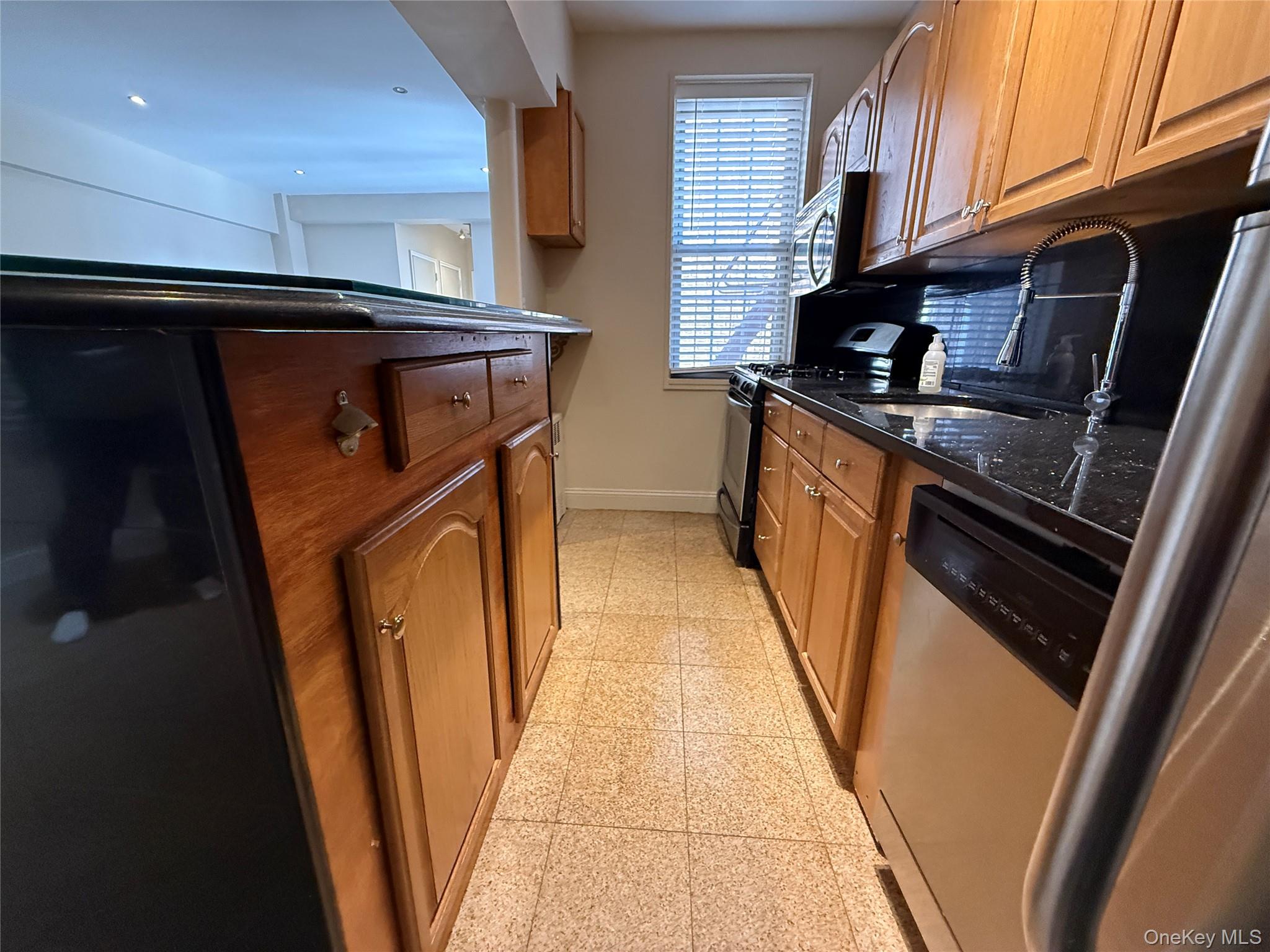 796 Bronx River Road, Unit B38 Bronxville, NY 10708 - Photo 25 of 31 a kitchen with a sink a washer and dryer