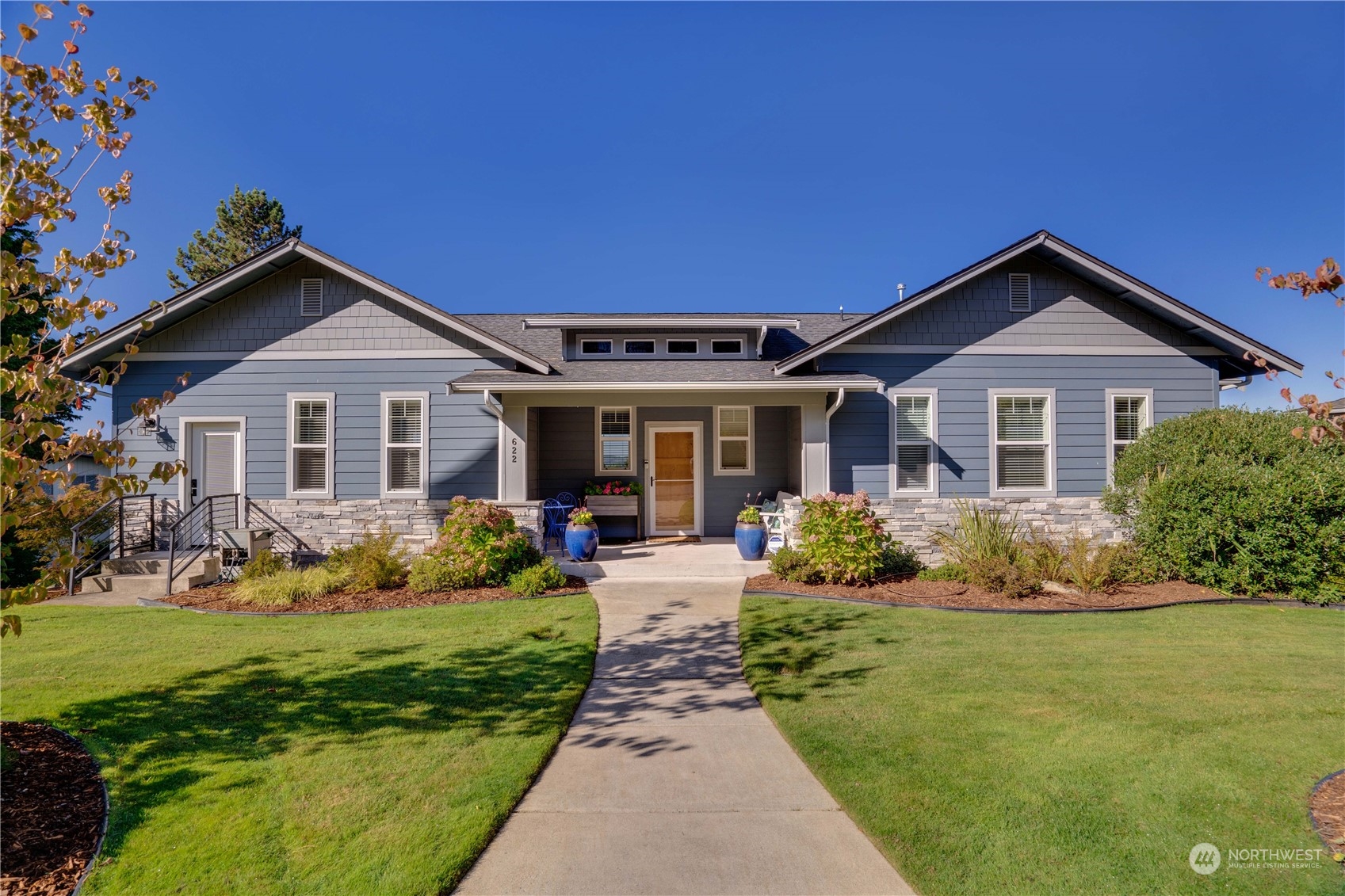 a front view of a house with a yard and porch