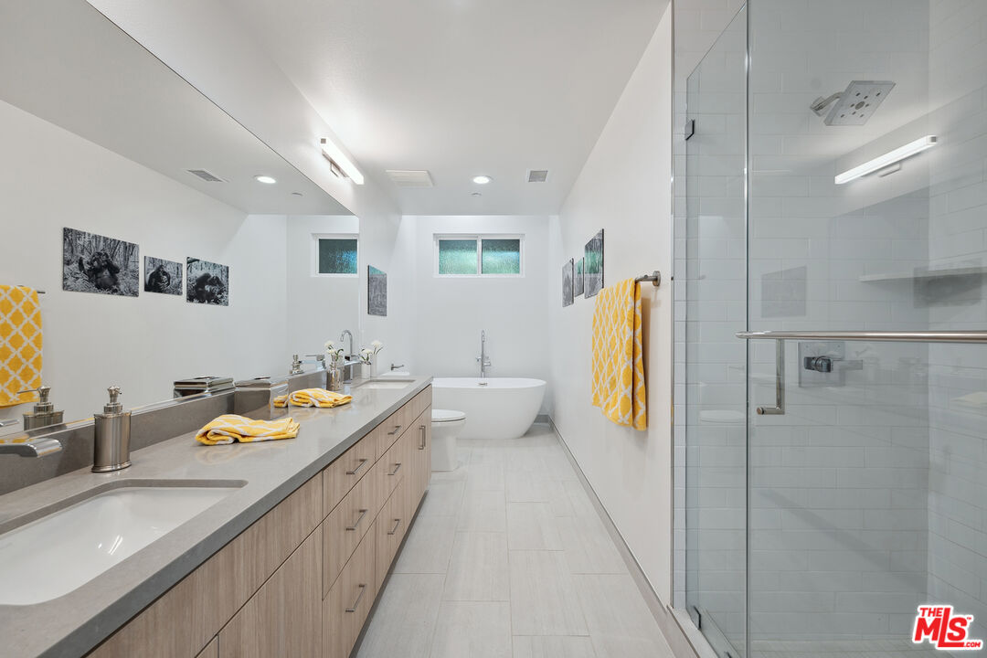 1746 Garfield Place, Unit 202 Los Angeles, CA 90028 - Photo 12 of 30 a bathroom with a double vanity sink and a mirror