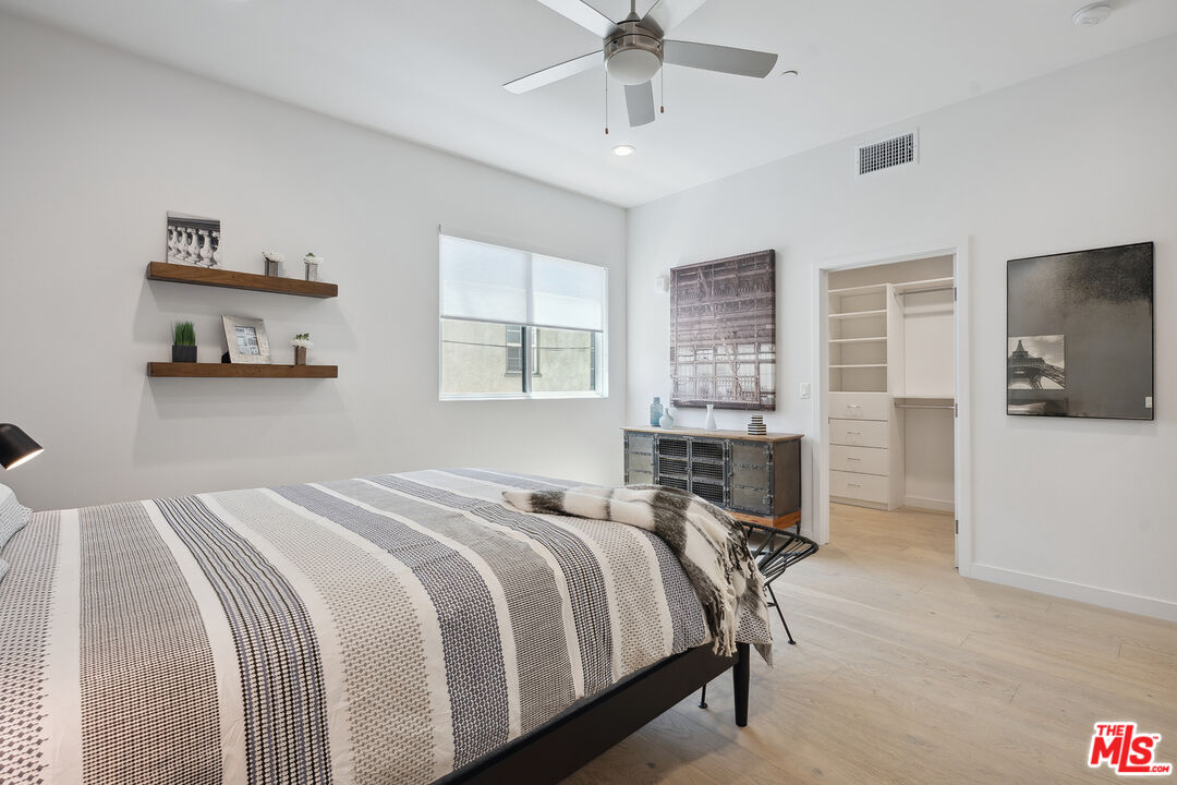 1746 Garfield Place, Unit 202 Los Angeles, CA 90028 - Photo 15 of 30 a bed room with a bed and a chair