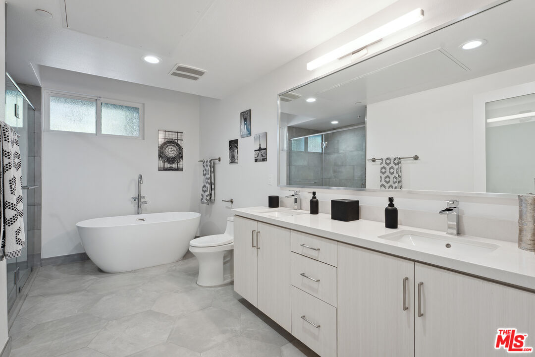 1746 Garfield Place, Unit 202 Los Angeles, CA 90028 - Photo 16 of 30 a spacious bathroom with a double vanity sink mirror and bathtub