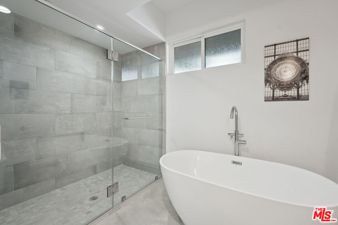 1746 Garfield Place, Unit 202 Los Angeles, CA 90028 - Photo 17 of 30 a bathroom with a bathtub and shower
