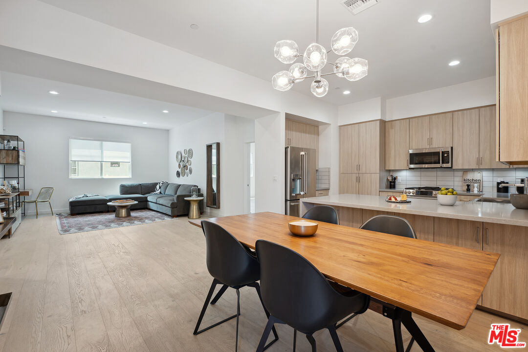 1746 Garfield Place, Unit 202 Los Angeles, CA 90028 - Photo 2 of 30 a large kitchen with a table and chairs