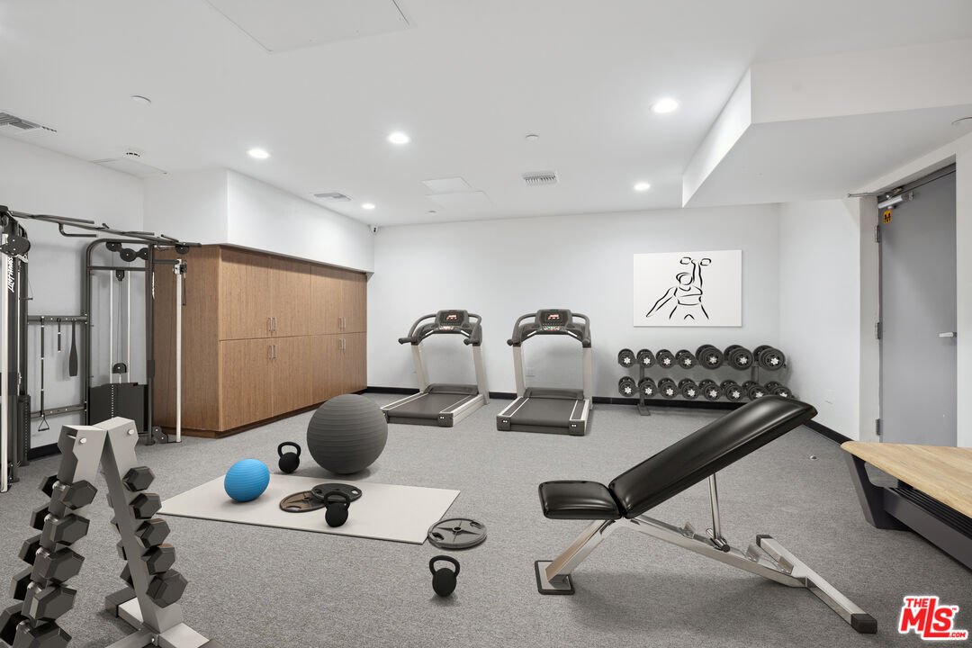 1746 Garfield Place, Unit 202 Los Angeles, CA 90028 - Photo 30 of 30 a room with furniture gym equipment and a chandelier