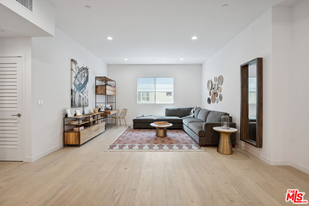 1746 Garfield Place, Unit 202 Los Angeles, CA 90028 - Photo 4 of 30 a living room with furniture windows and a wooden floor