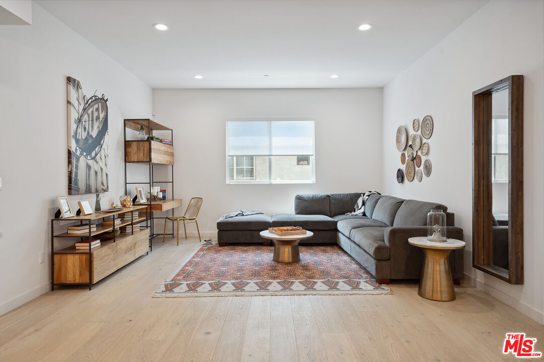 1746 Garfield Place, Unit 202 Los Angeles, CA 90028 - Photo 5 of 30 a living room with furniture and a flat screen tv