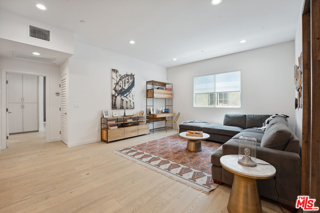 1746 Garfield Place, Unit 202 Los Angeles, CA 90028 - Photo 6 of 30 a living room with furniture and a table