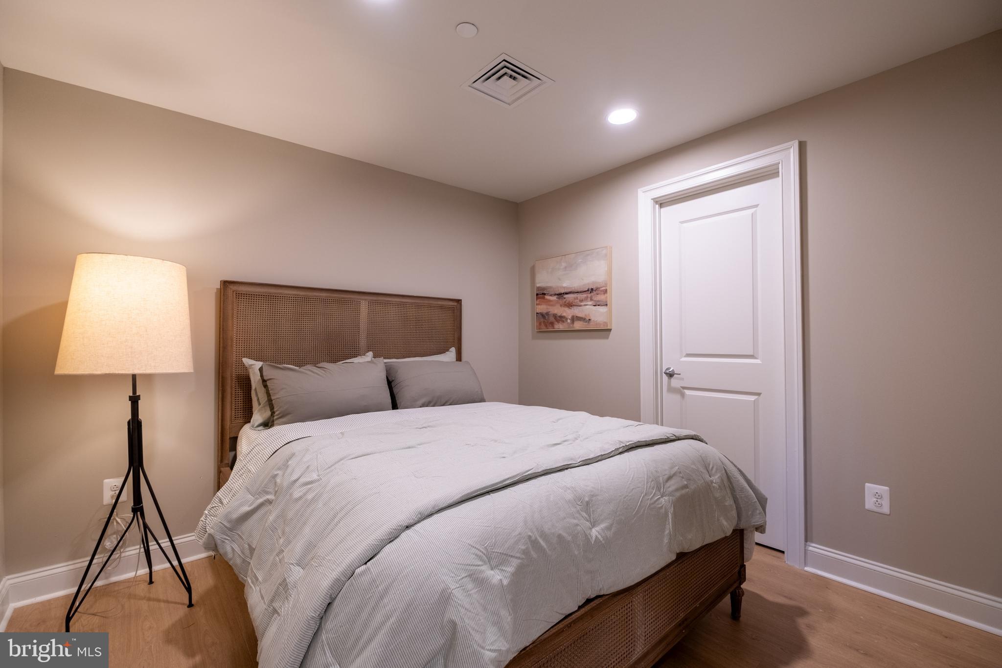 2301-61 John F Kennedy Boulevard, Unit 104 Philadelphia, PA 19103 - Photo 46 of 47 a bedroom with a bed and a lamp