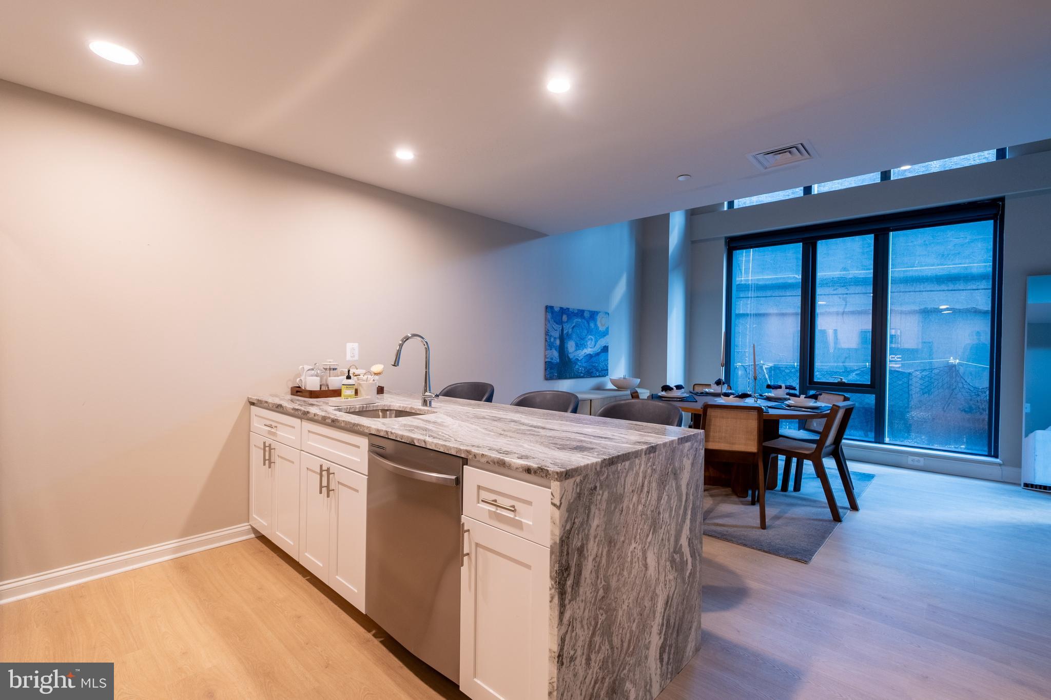 2301-61 John F Kennedy Boulevard, Unit 104 Philadelphia, PA 19103 - Photo 6 of 47 a view of a kitchen area with furniture and wooden floor
