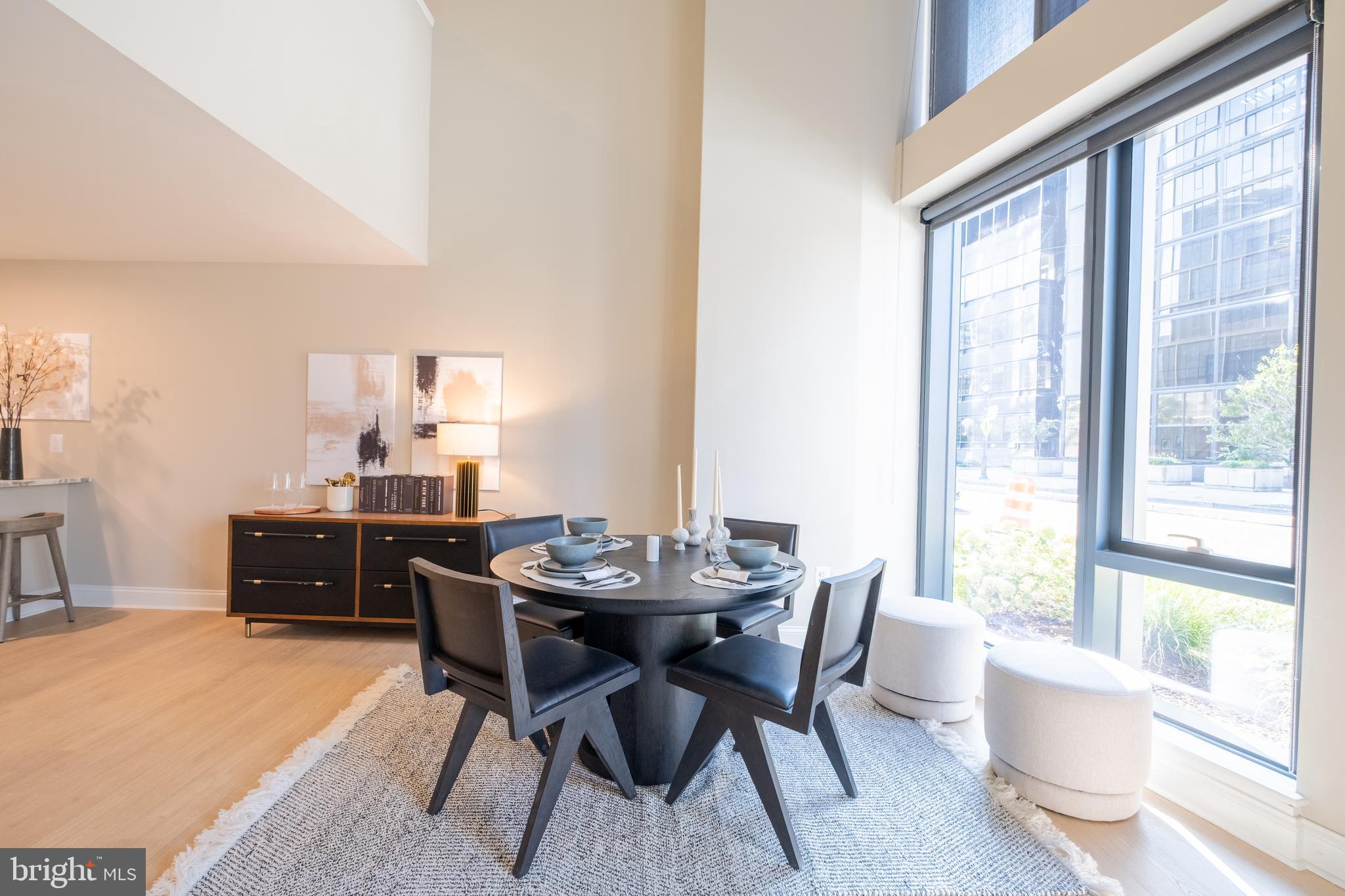 2301-61 John F Kennedy Boulevard, Unit 104 Philadelphia, PA 19103 - Photo 9 of 47 a dining room with furniture and wooden floor
