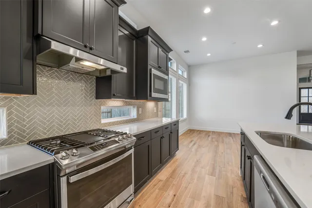 a kitchen with a stove and a sink