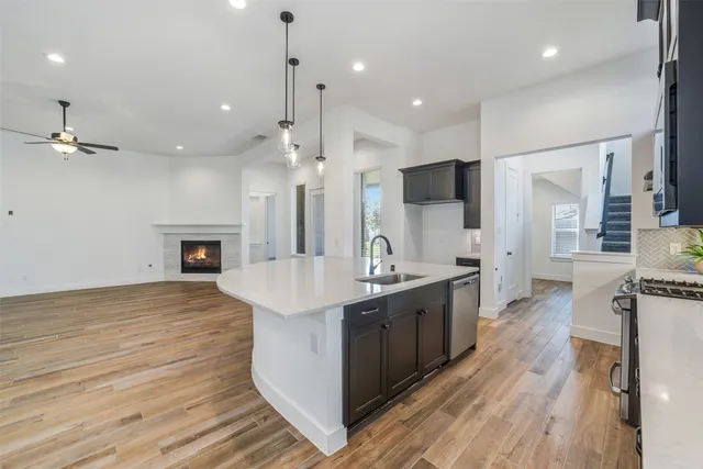 a large kitchen with stainless steel appliances kitchen island a large island in the center and wooden floor