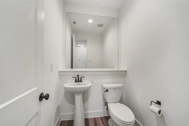 a white toilet sitting next to a bathroom sink