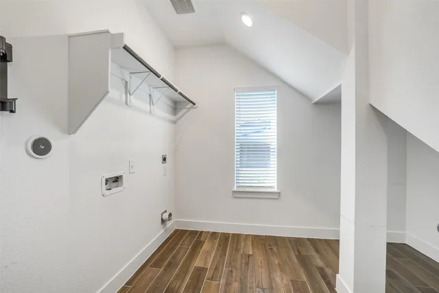 a view of a room with rack on the wall and a window