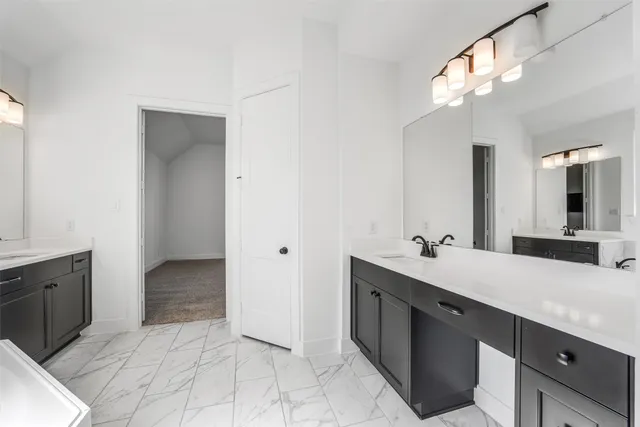 a spacious bathroom with a double vanity sink and a mirror