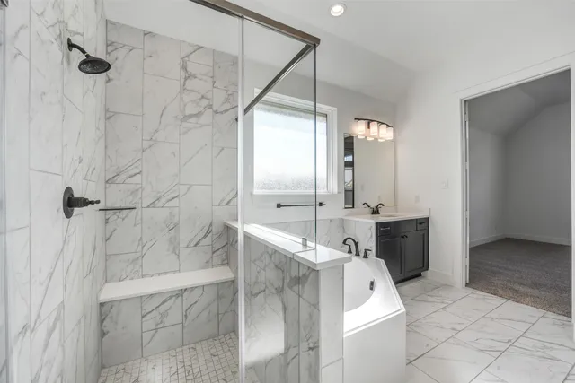 a bathroom with a tub sink and mirror