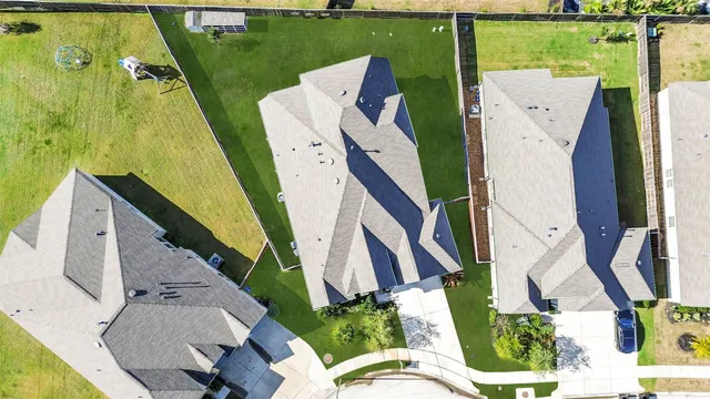 an aerial view of a house with a garden and plants