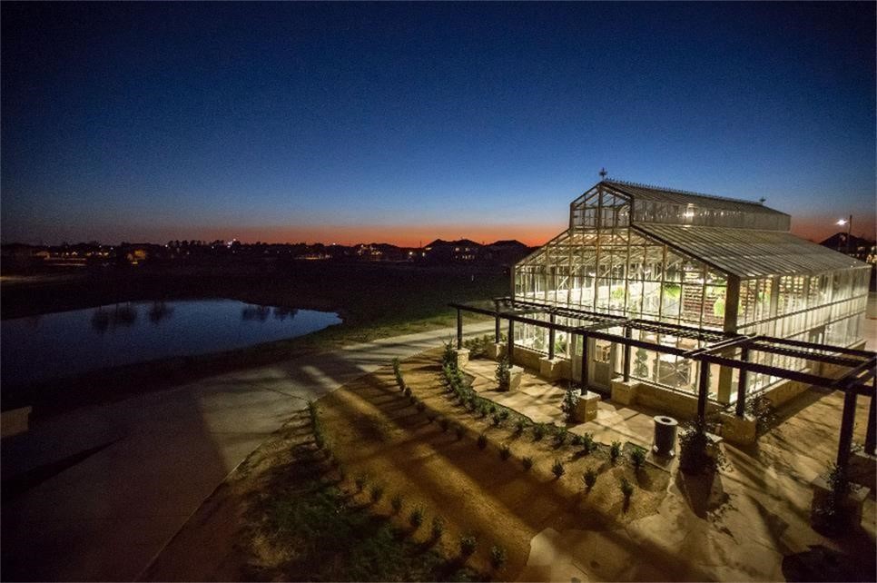 1703 Rosings Way Katy, TX 77493 - Photo 48 of 50 Cane Island's Conservatory is a gorgeous green house that has been designed for so many uses. There have been neighborhood wine nights, weddings and Prom Photo Shoots in this space. How would you enjoy it as a neighbor? You can rent it out for your event. Night aerial view of The Conservatory which lets you see what it could look like while attending an event there like Wine Nights or extended dining room events. Beautiful space.
