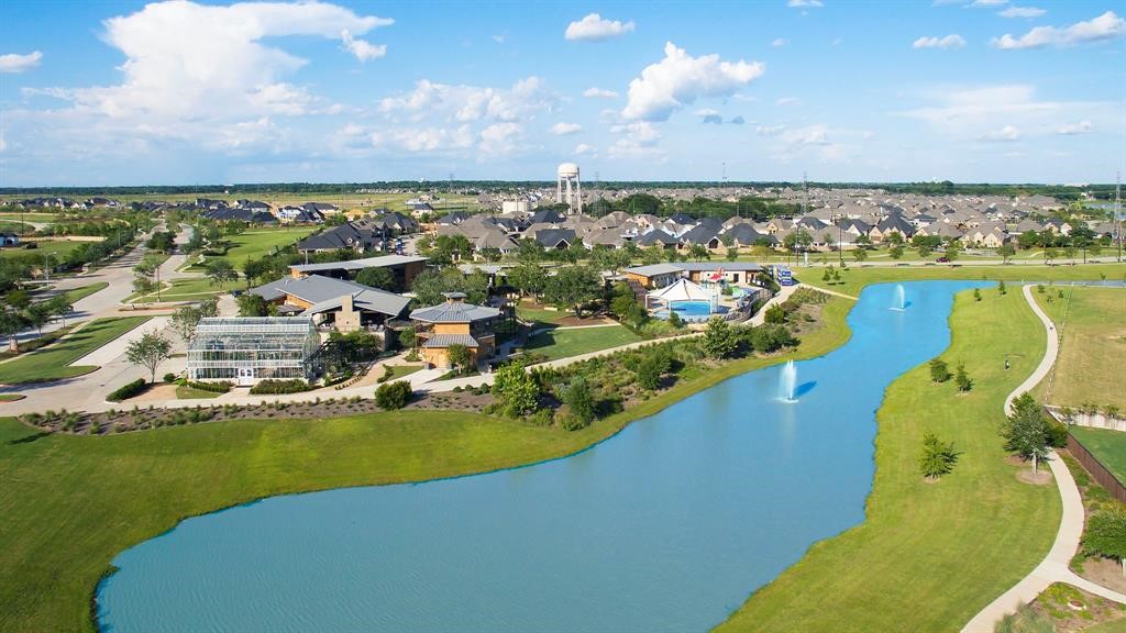 1703 Rosings Way Katy, TX 77493 - Photo 49 of 50 Aerial view of Cane Island's wet areas. You have a family pool with lifeguards, cabanas, covered section or a Huge splash bucket on one side and across the breezeway is an lap pool for those that are serious about their water workouts. Either way, such a fun area of Cane Island!