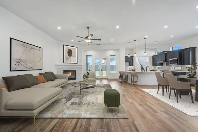 a living room with fireplace furniture and a wooden floor